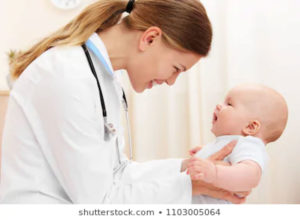 Female pediatrician smiling at a baby