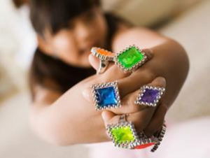 Child wearing colorful toy rings