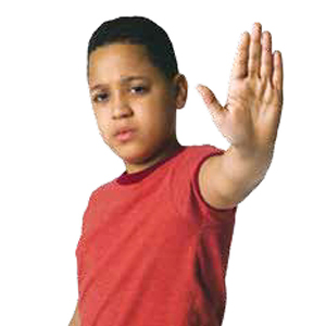 Boy in red shirt holding hand out in a 'stop' gesture