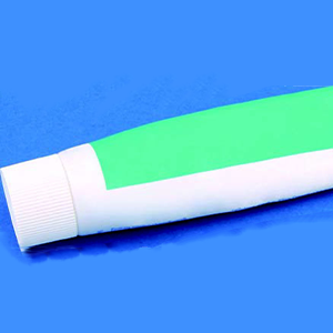Toothpaste laying on blue background