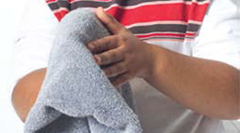 Child holding towel between hands